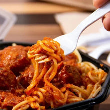 White plastic fork lifting spaghetti over a pasta dish