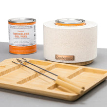 Solo Stove fire bowl on wood base with gel fuel can and crackers on board