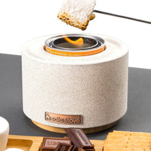 Solo Stove fire bowl with flame showing and marshmallow on a long skewer