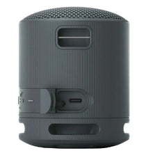 Dark gray portable speaker back with carry handle and charging port opening
