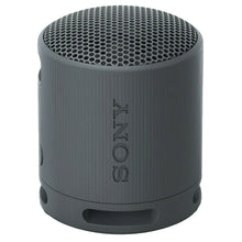 Dark gray portable Bluetooth speaker angled view with top mesh grille