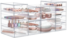 Clear acrylic drawer organizer with multiple stackable compartments for cosmetics