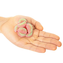 Watermelon soft and chewy candy pieces held in a hand