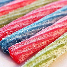 Close-up of sour candy sticks with pink, blue, and green sugary coating