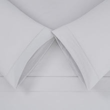 Solid white microfiber sheet set with stitched corners and layered folds