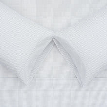 White microfiber fabric close-up with small diamond texture and stitched seams
