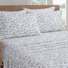 Microfiber sheet set showing gray dog-print pillowcases and matching sheet on a bed