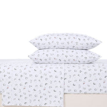 Microfiber sheet set with white dog print pillowcases, decorative accents, and folded sheets