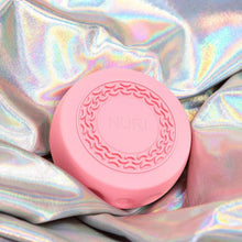 Pink circular NURI skincare infuser base with embossed pattern