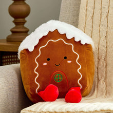 Plush gingerbread house baby toy with red feet, brown body, white roof