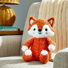 Orange fox plush toy with white muzzle and paws, sitting pose, soft textured fur