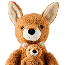 Close-up of brown kangaroo plush face with small pouch kangaroo
