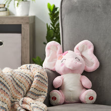 Pink plush elephant toy sitting on a chair, striped belly and button feet