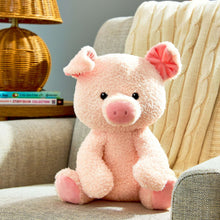Soft pink pig plush toy sitting pose, with fuzzy texture and floppy ears.