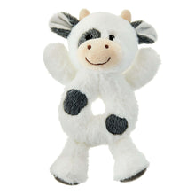 Plush cow rattle with white fur, tan snout, black patches and floppy ears