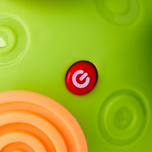 Green bumpie ball close-up with red power button and embossed circle textures