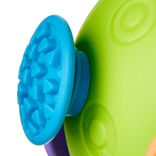 Green ball with blue ribbed textured side and purple rim, close-up
