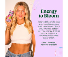 Bloom energy drink can held by model, citrus and fruit illustration on label