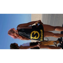 Spikeball net set with yellow balls carried outdoors