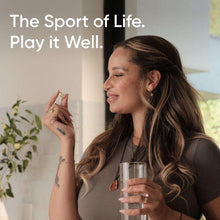 Omega-3 fish oil supplement concept with woman holding a drink and softgel