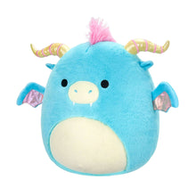 Front-facing blue dragon plush with cream belly, pink tuft, rainbow striped horns, and wings