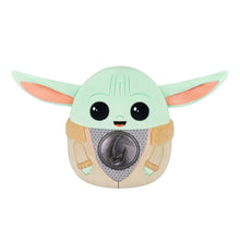 Light green and tan plush Grogu with dark gray chest emblem and black eyes