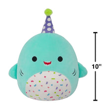 Teal shark plush with purple polka-dot party hat, confetti belly, smiling face.