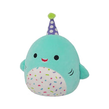Teal shark plush with purple polka-dot party hat, confetti belly patch, smiling.