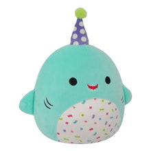 Teal shark plush with purple polka-dot party hat and confetti belly, smiling.