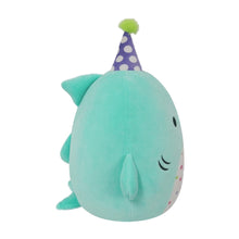 Teal shark plush with purple party hat, green pom, smiling face, soft stuffed body.