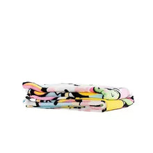 Folded throw blanket stack with multicolor cartoon pattern