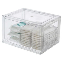Stackable clear shoe organizer with folded towels and a pair of light shoes