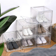 Multiple clear stackable shoebox organizers holding shoes in separate bins