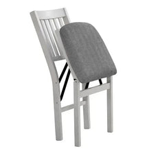 Light wood folding upholstered chair with gray padded seat and slatted back in angled view