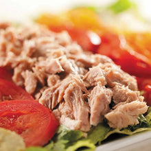 Chunk light tuna with lettuce and tomato in a close-up food serving