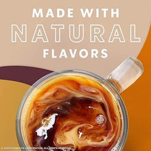 Iced coffee in a glass cup with amber swirling coffee