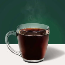 Glass mug filled with dark French roast coffee