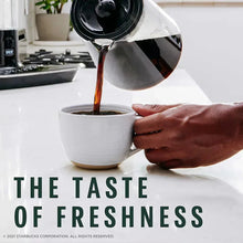 Coffee being poured into a white cup