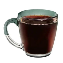 Glass mug filled with dark brewed coffee