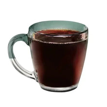 Clear glass mug of dark coffee