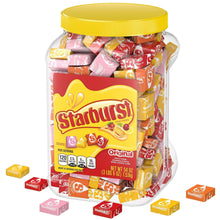 Starburst Original chewy candy jar with yellow lid and wrapped candies, plus a few cubes nearby