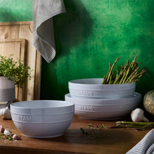 Staub serving bowl set: two white ceramic bowls with embossed STAUB marks