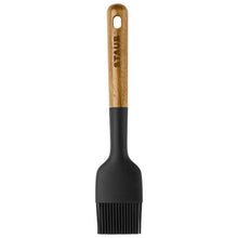 Basting brush with black bristles and light wood handle