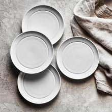 Staub white dinnerware set with round plates and bowls, matte finish
