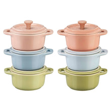 Two pastel ceramic mini Dutch ovens with lids, stacked on blue and green bases
