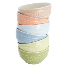 Stack of pastel ceramic mini bowls in blue, green, and pink with STAUB lettering