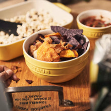 Yellow stoneware bowls, set of 2, embossed STAUB logo, filled with snacks