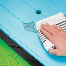 Picnic table surface being wiped with a cloth