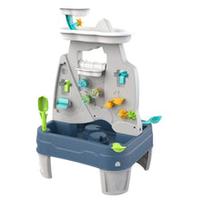 Children's water play table with waterfall sprayer and green and blue toy pieces