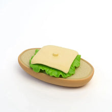 Picnic basket food set with open-faced sandwich and green lettuce filling